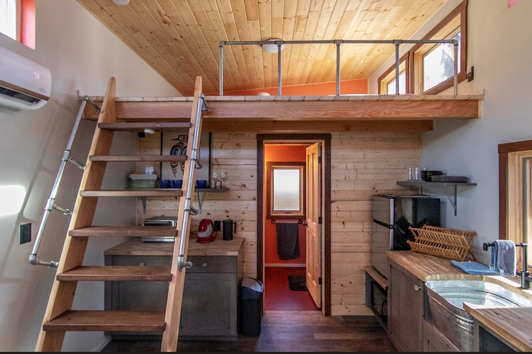 Photo of both the kitchen area, and also staircase up to the bedroom loft area.