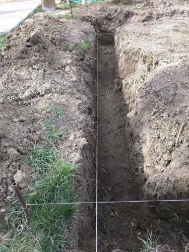 Initial trench being dug, with string lines to guide where the trenches need to go.
