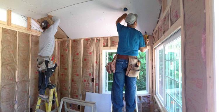 Lots of R-13 insulation fibreglass roll insulation in-between the vertical wood studs, as can be seen on 3 different walls, from Tuff Shed.