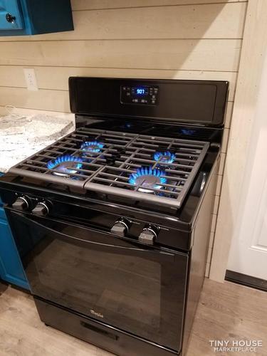 Gas stove with all four gas hobs currently on.