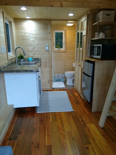 Another useful look at the whole downstairs, including kitchen area. This time with the bathroom door open.
