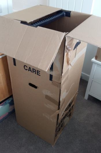 A battered packing box which can be used to store and transport clothes.