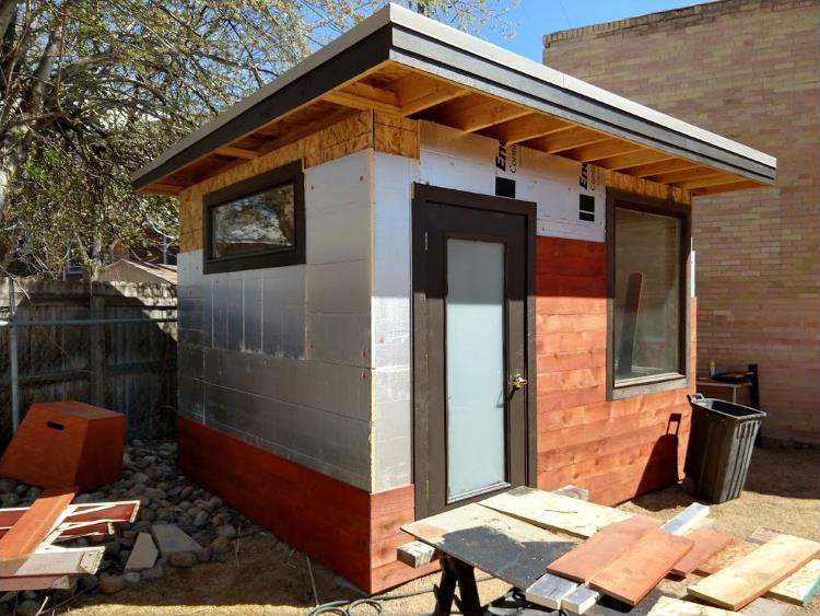 1 inch foam insulation and then stained-red cedar wood attached to the wood sheathing outside the backyard office, from Mr Money Mustache.