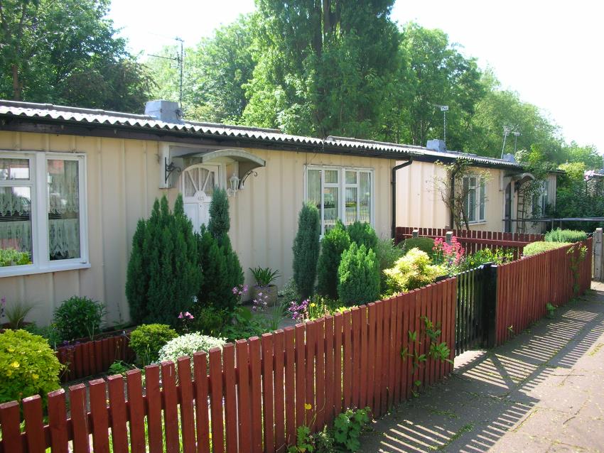 A row of United Kingdom post-War prefab houses, this one built by a company called Phoenix, from Wikipedia.
